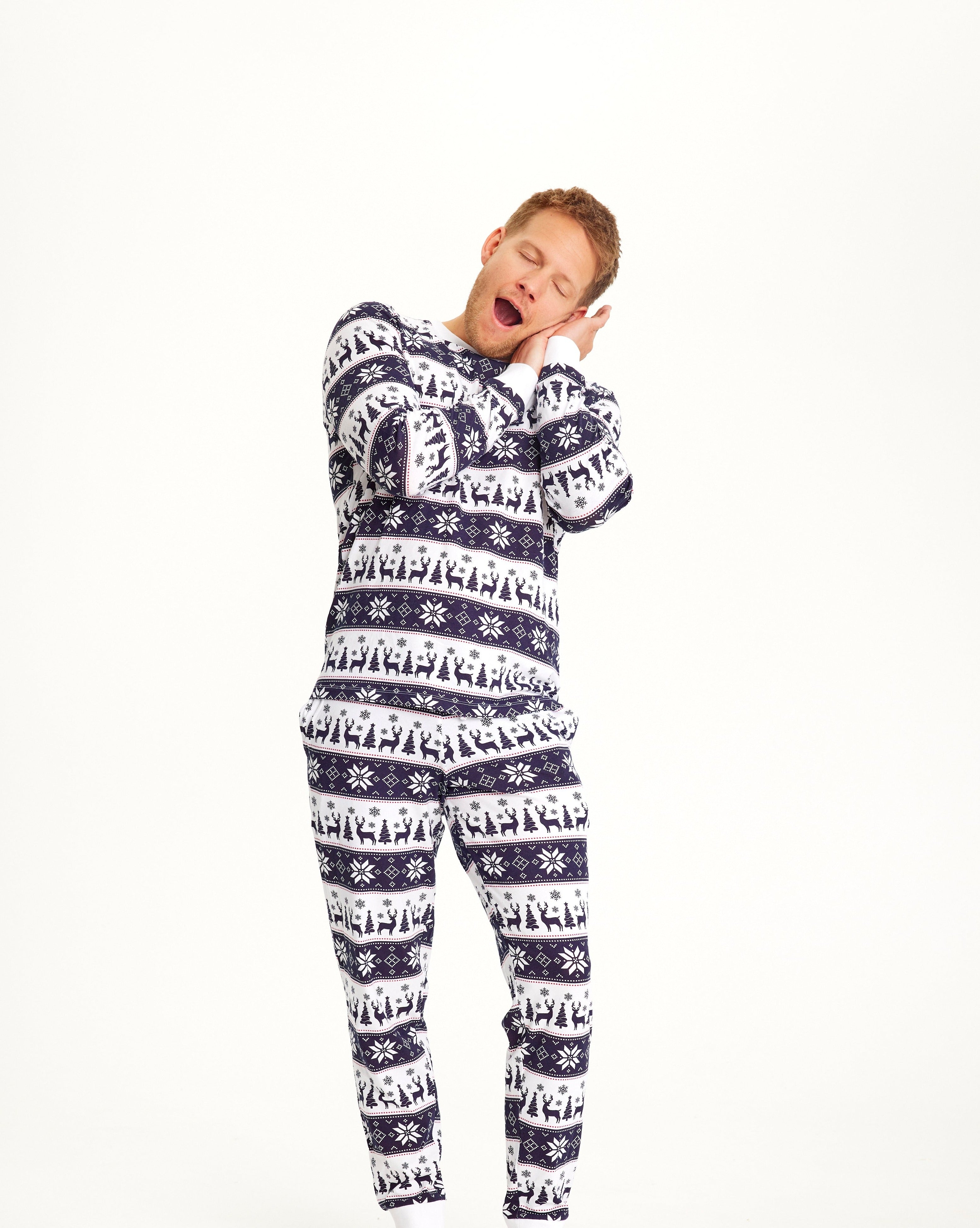Een slapende man in een blauw-wit gestreepte kerstpyjama.